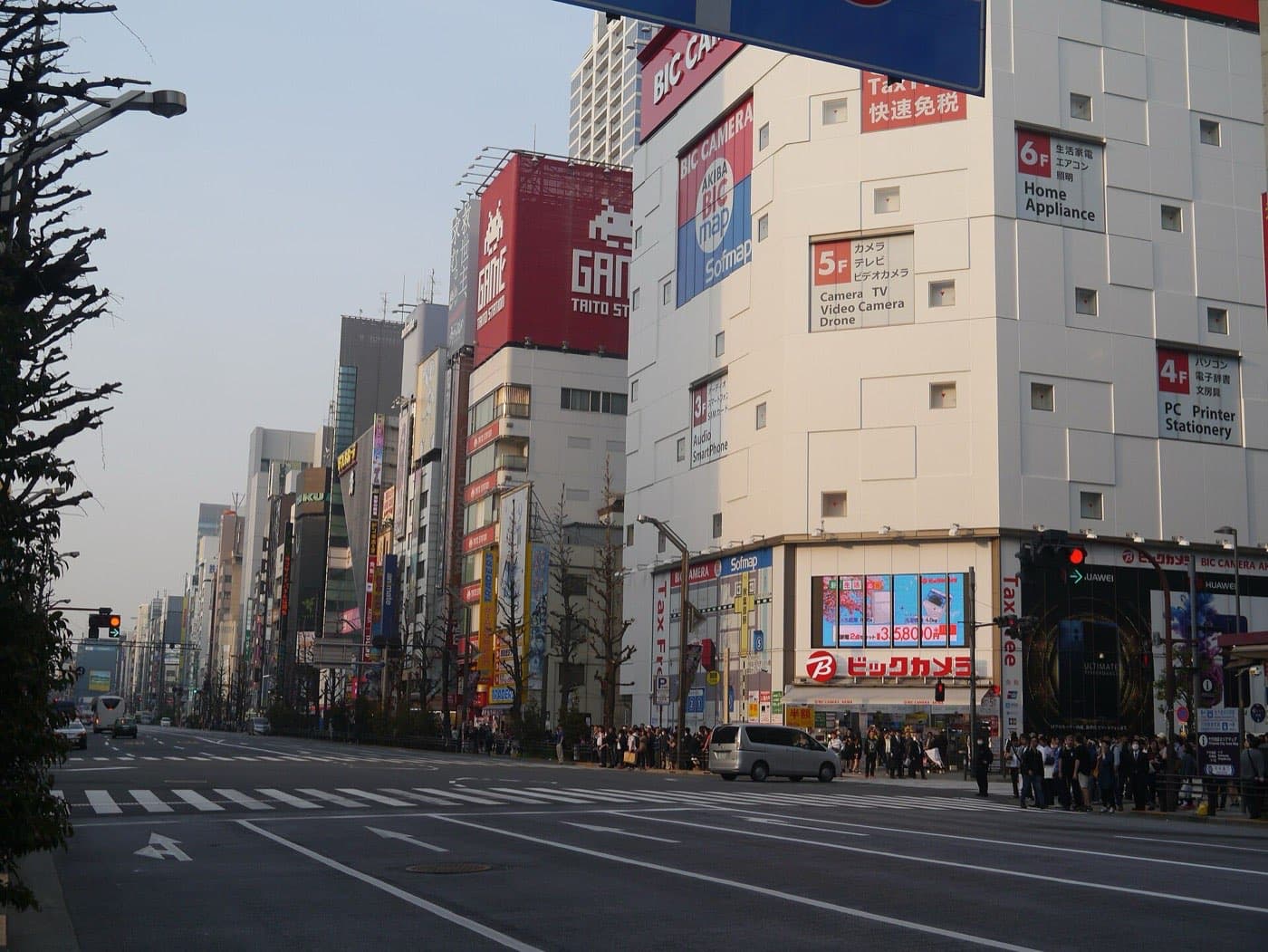 Wide street crossing in Akihabara Electric Town on a clear day, lined with shop buildings