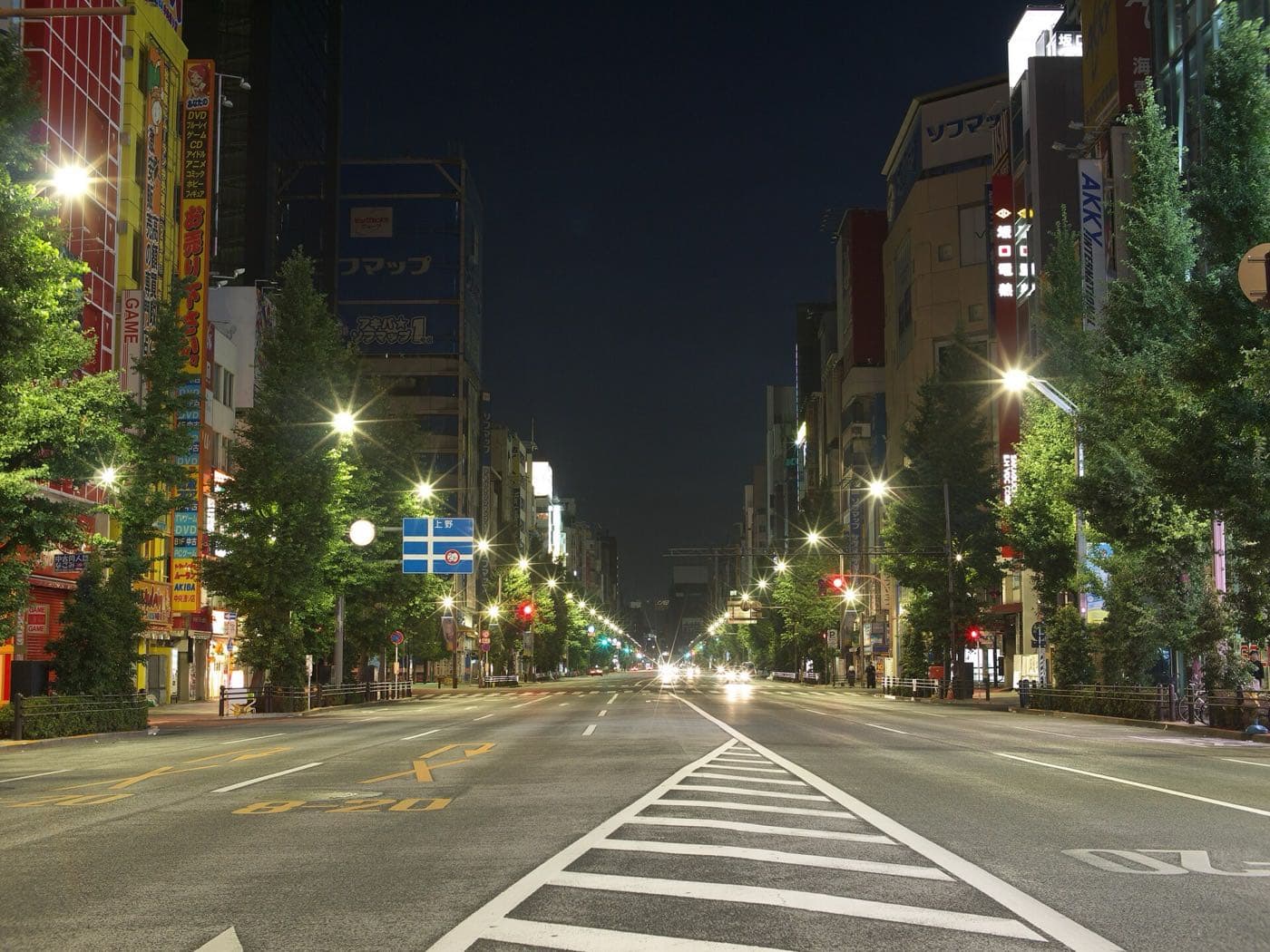 Empty Chūō-dōri avenue in Akihabara lit by street lamps in the early morning