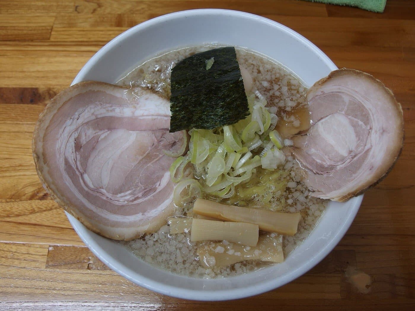 Bowl of shōyu ramen with two slices of chāshū pork, nori, green onion and bamboo shoots