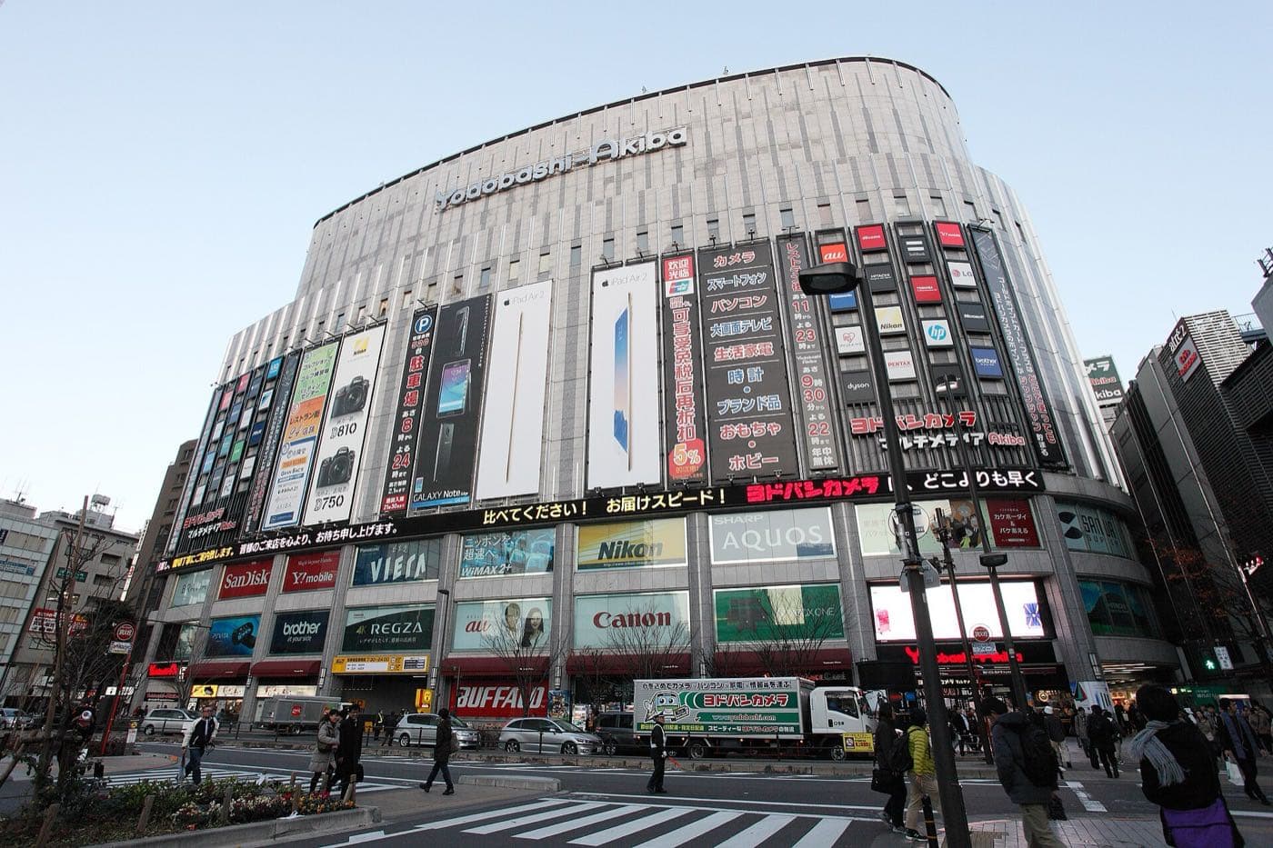 Curved facade of the Yodobashi-Akiba building with product advertising panels